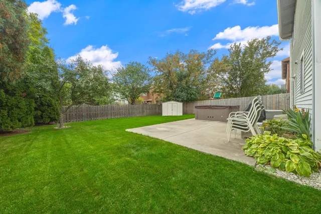 a backyard of a house with table and chairs