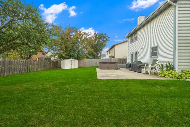 a backyard of a house with table and chairs