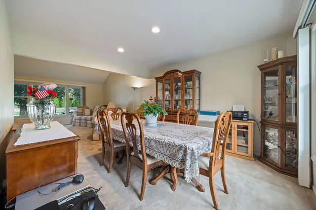 a view of a dining room with furniture and a potted plant