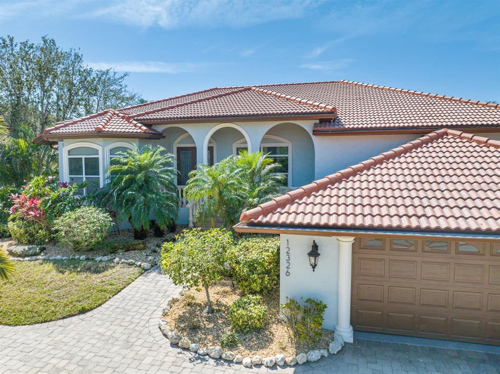 12326 Baypointe Terrace Cortez, FL 34215 - Photo 1 of 59 a front view of a house with garden