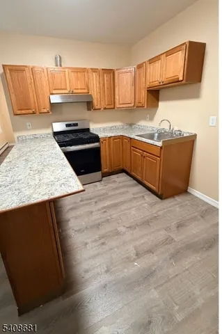 a kitchen with stainless steel appliances granite countertop a sink counter space and cabinets