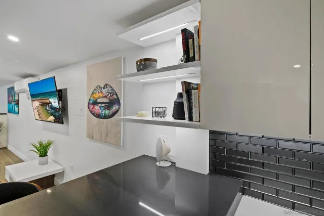 a view of a hallway with workspace and wooden floor