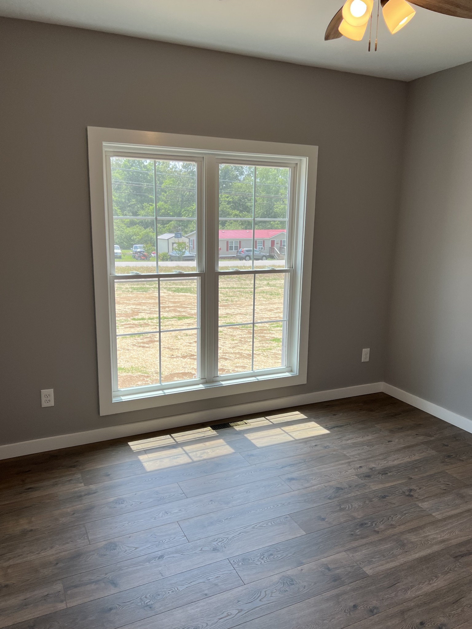 1504 Fall River Road Lawrenceburg, TN 38464 - Photo 14 of 15 a view of an empty room with wooden floor and a window