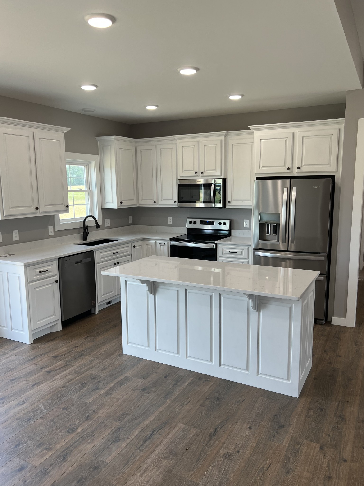 1504 Fall River Road Lawrenceburg, TN 38464 - Photo 3 of 15 a kitchen with stainless steel appliances a microwave a sink a stove a microwave and cabinets