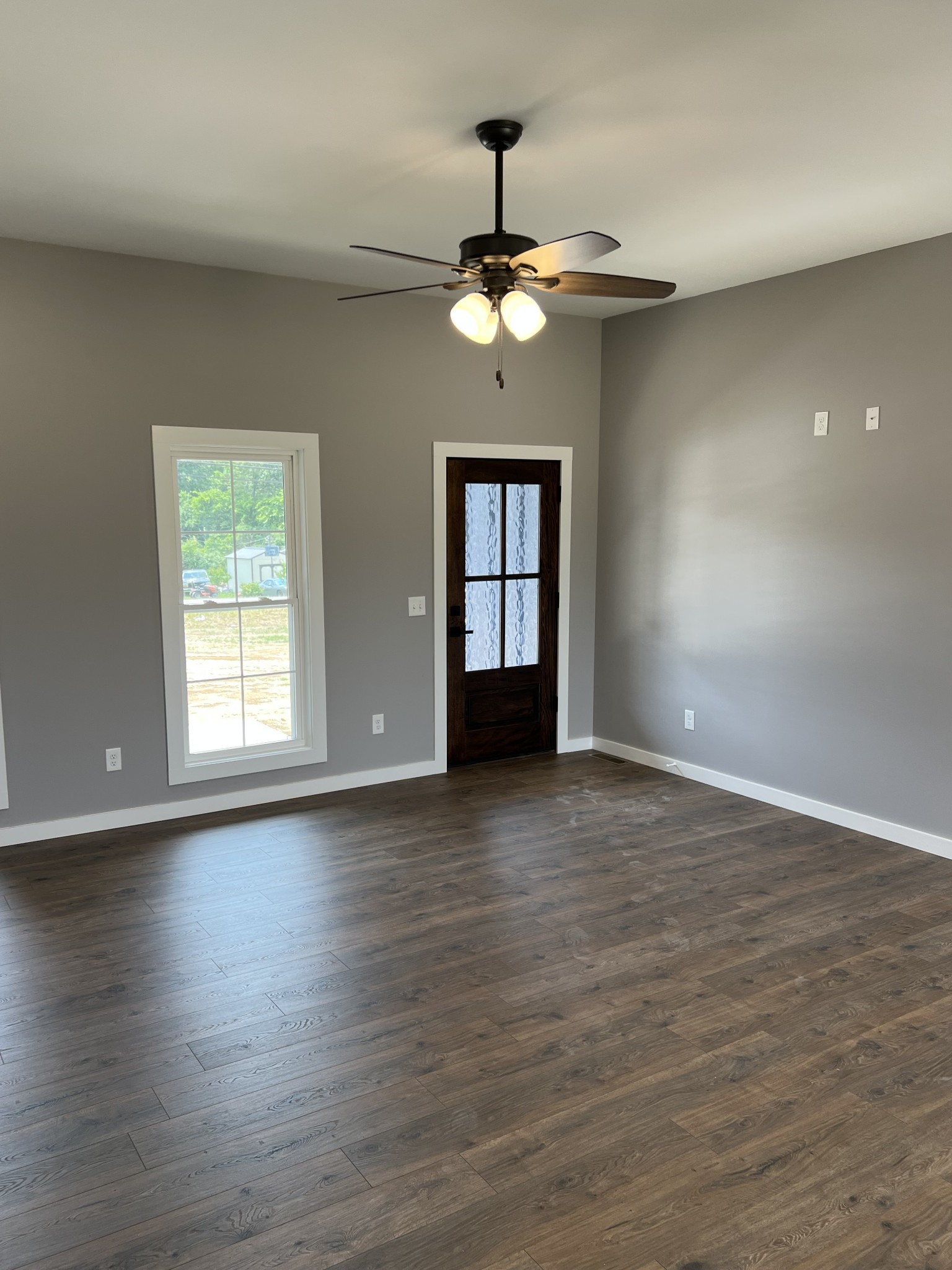 1504 Fall River Road Lawrenceburg, TN 38464 - Photo 4 of 15 a view of an empty room with wooden floor and a window