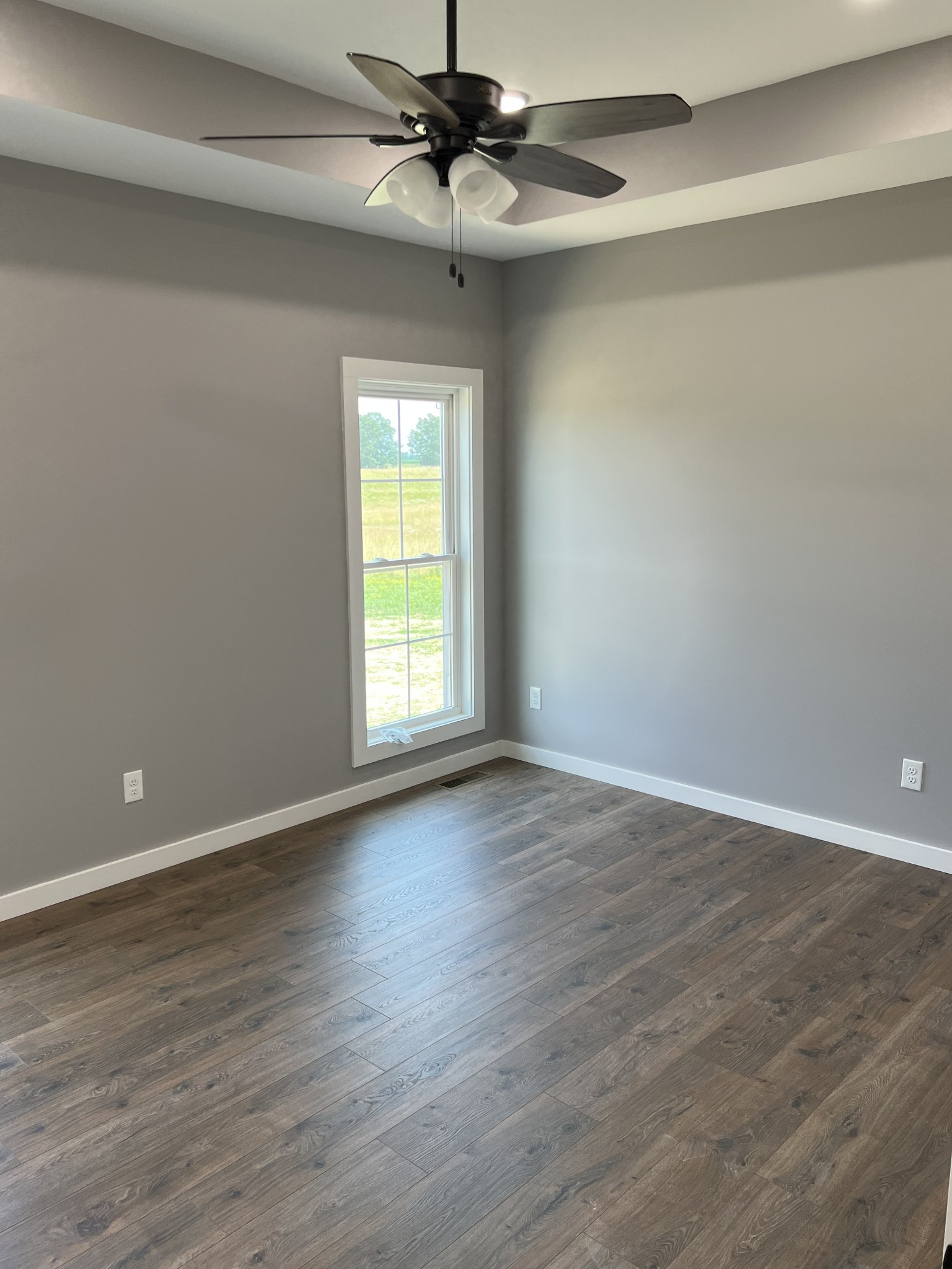 1504 Fall River Road Lawrenceburg, TN 38464 - Photo 8 of 15 wooden floor in an empty room with a window