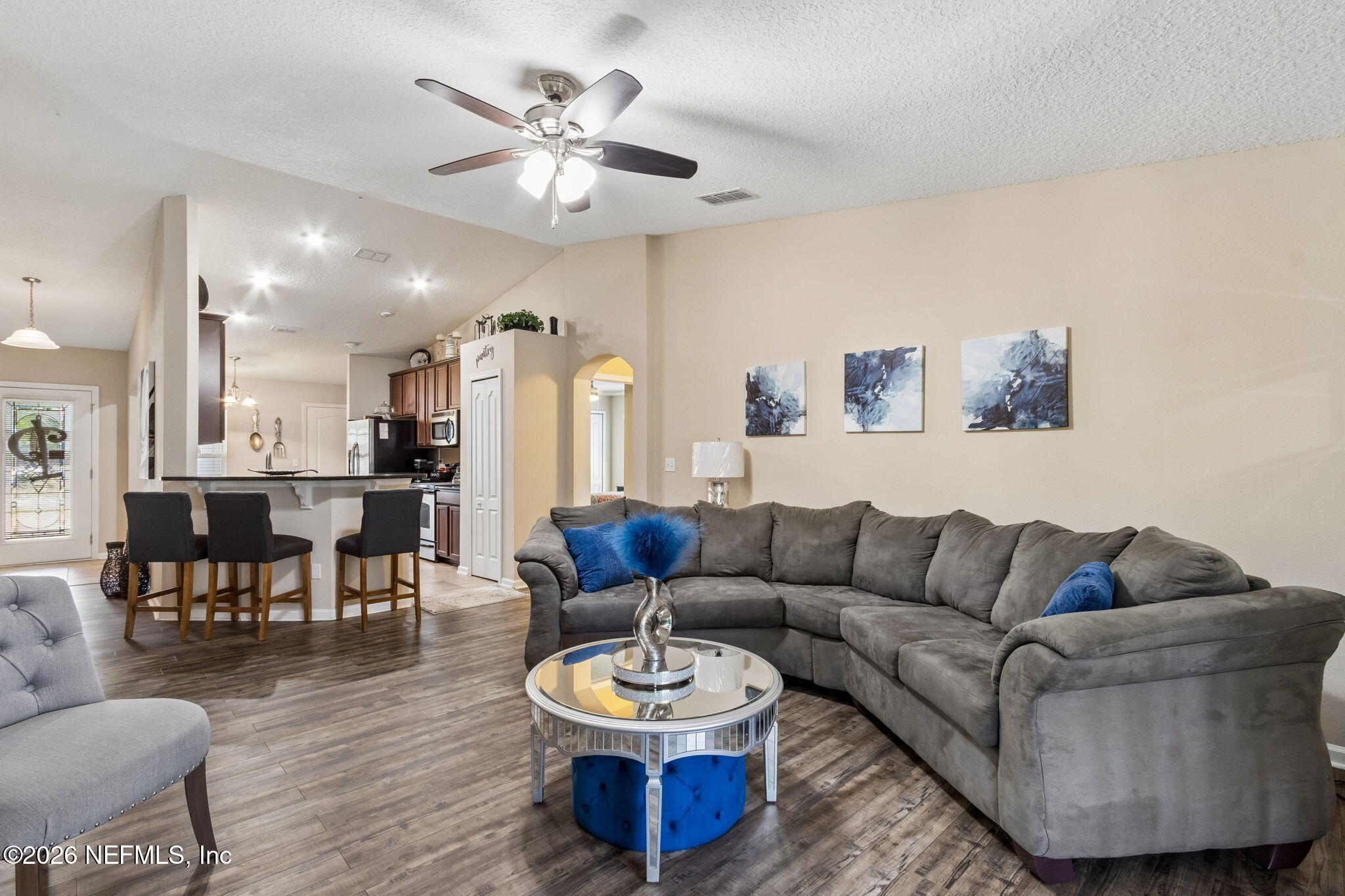 96034 Bass Lane Yulee, FL 32097 - Photo 15 of 50 a living room with furniture and a dining table with wooden floor