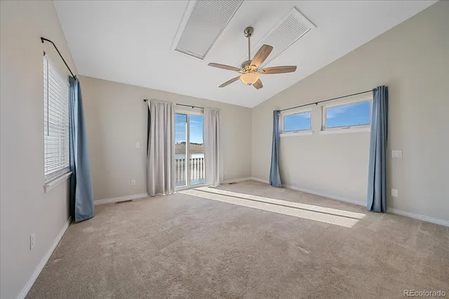 a view of a livingroom with a ceiling fan and window