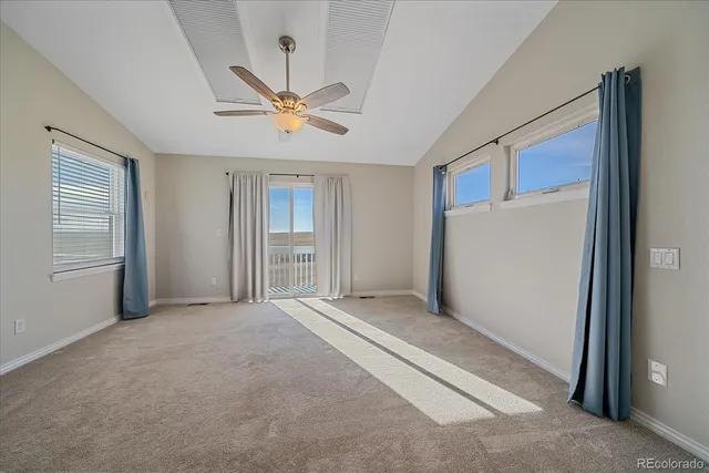 a view of a livingroom with a ceiling fan and window