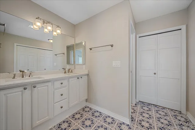 a spacious bathroom with a double vanity sink and mirror