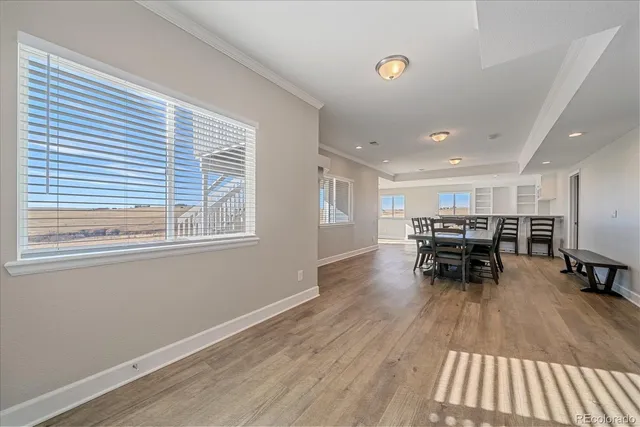 a dining room with furniture and wooden floor