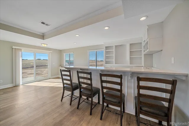 a dining room with furniture and wooden floor
