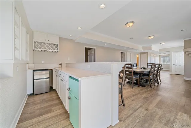 a kitchen with a sink and chairs