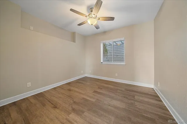wooden floor in an empty room with a window