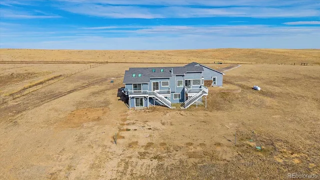 a view of a roof deck with wooden floor and fence