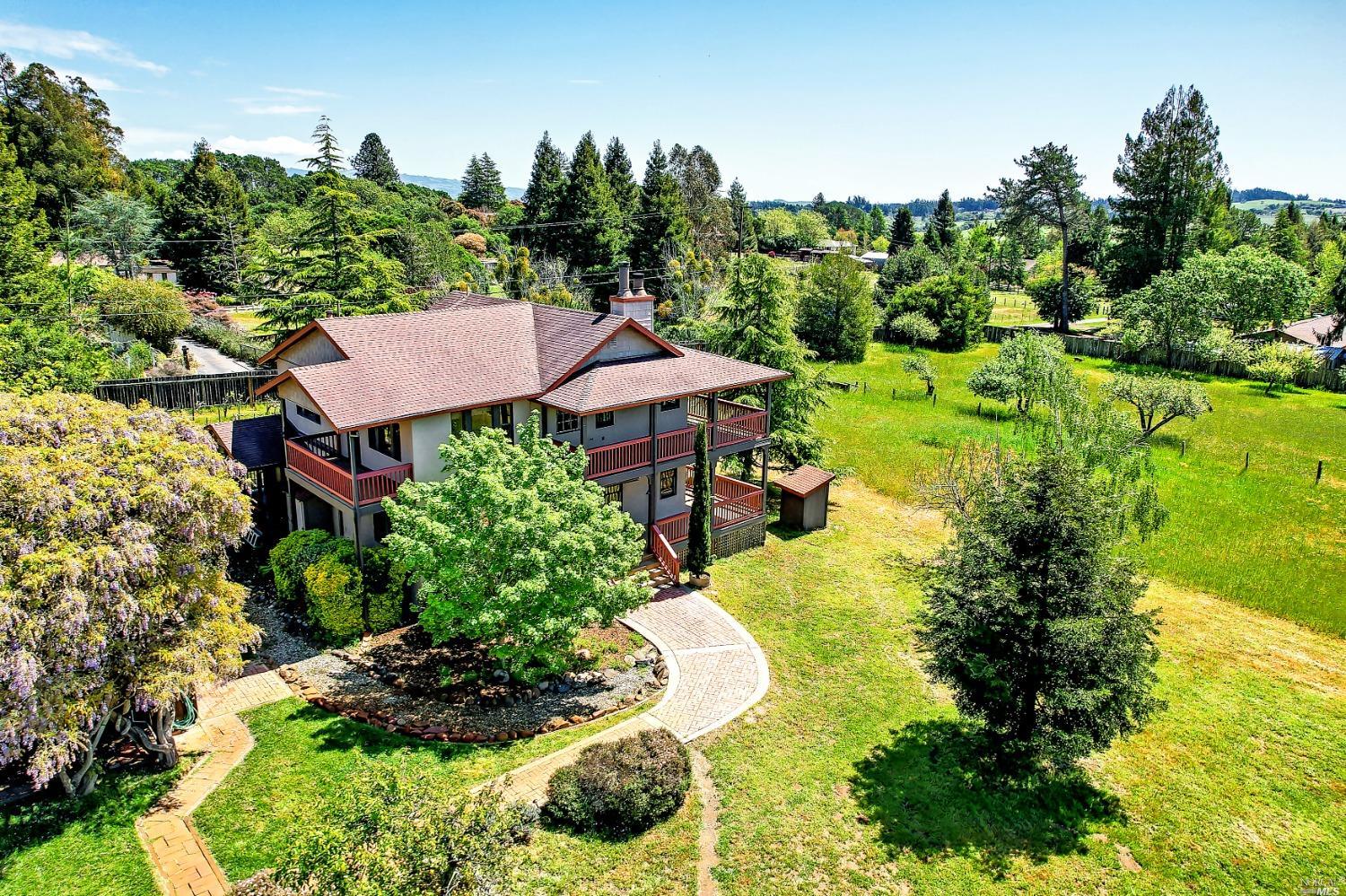 1475 Schaeffer Road Sebastopol, CA 95472 - Photo 1 of 1 a view of a house with a yard and garden