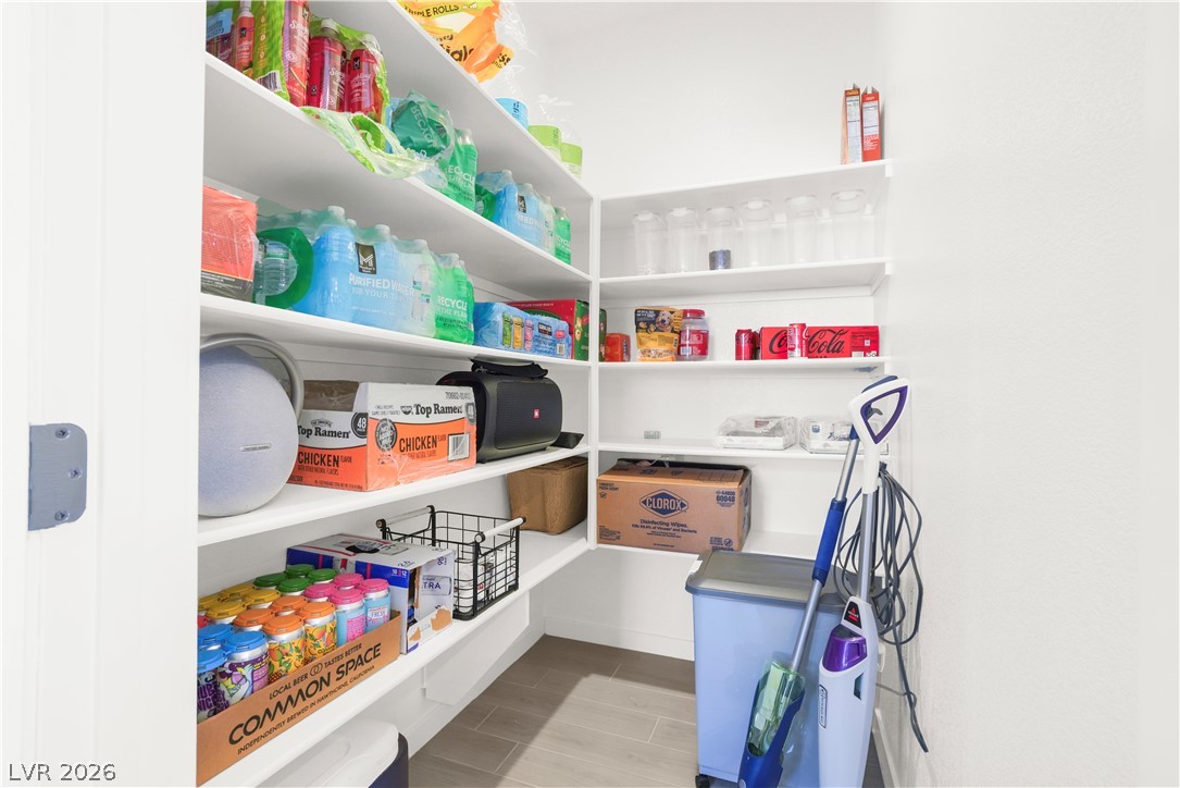 9398 Noble Fir Rdg Court Las Vegas, NV 89143 - Photo 12 of 36 A well-organized pantry features ample shelving and durable flooring, maximizing storage capacity.