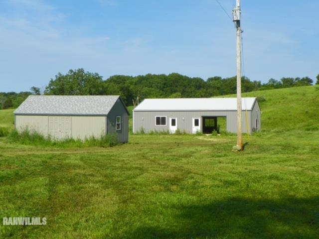 17658 Scenic Ridge Road Savanna, IL 61074 - Photo 1 of 24 a front view of a house with a garden and yard