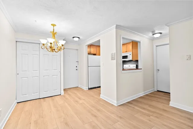 a view of an entryway with wooden floor