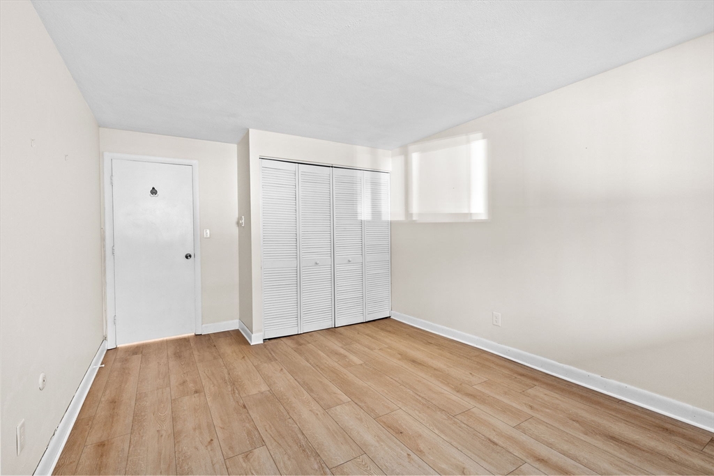 79 Fountain Lane, Unit 3 Weymouth, MA 02190 - Photo 18 of 29 a view of an empty room with wooden floor