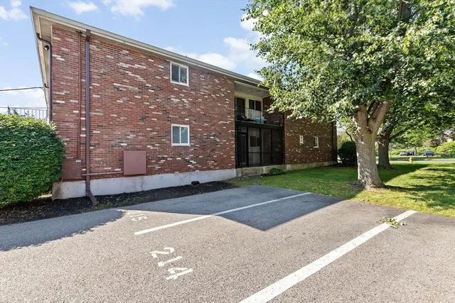 a brick building with a tree in front of it