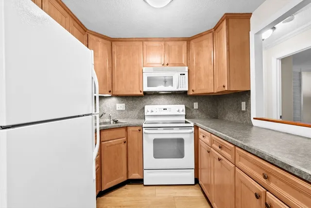 a kitchen with stainless steel appliances granite countertop cabinets and a refrigerator