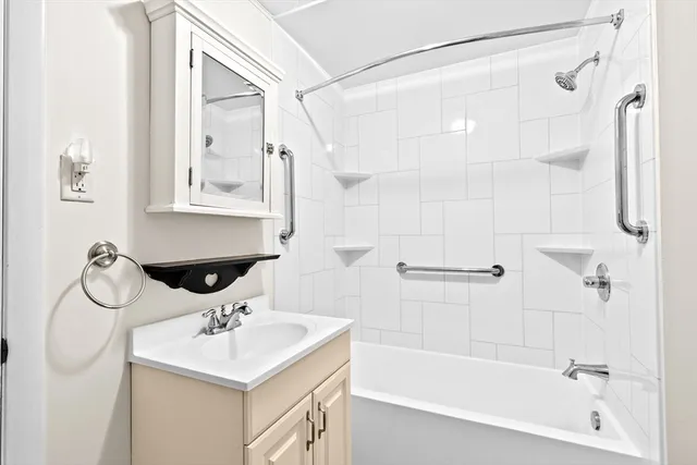 a bathroom with a sink mirror toilet and bathtub