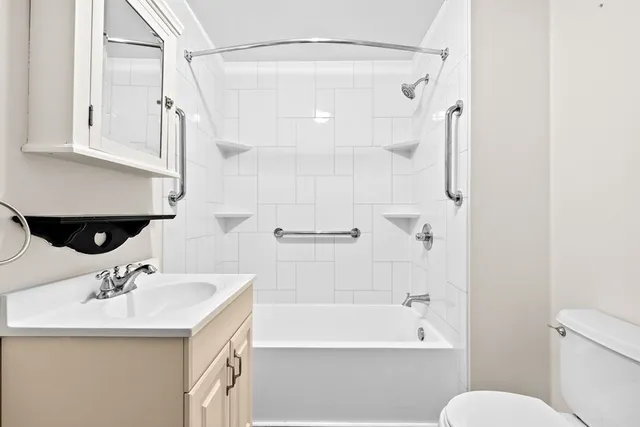 a bathroom with a sink toilet and shower