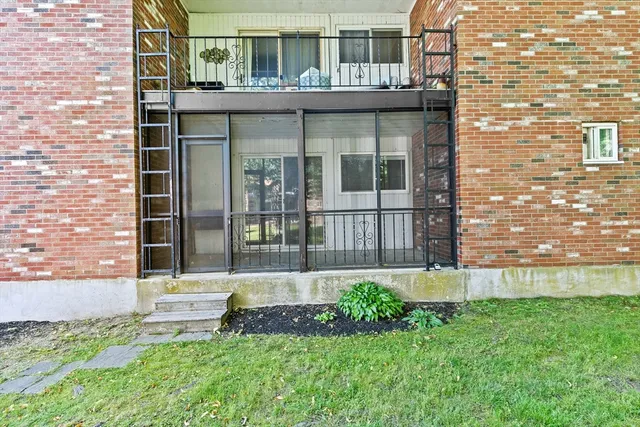 a view of a house with a yard and sitting area