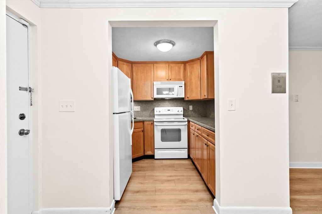 79 Fountain Lane, Unit 3 Weymouth, MA 02190 - Photo 3 of 29 a kitchen with a refrigerator a stove top oven
