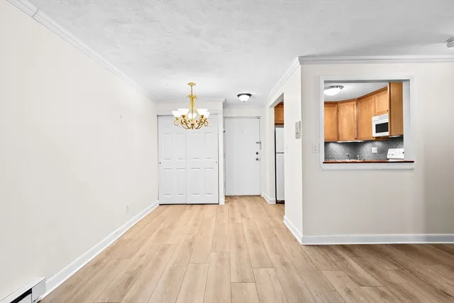 a view of a room with wooden floor and an entryway