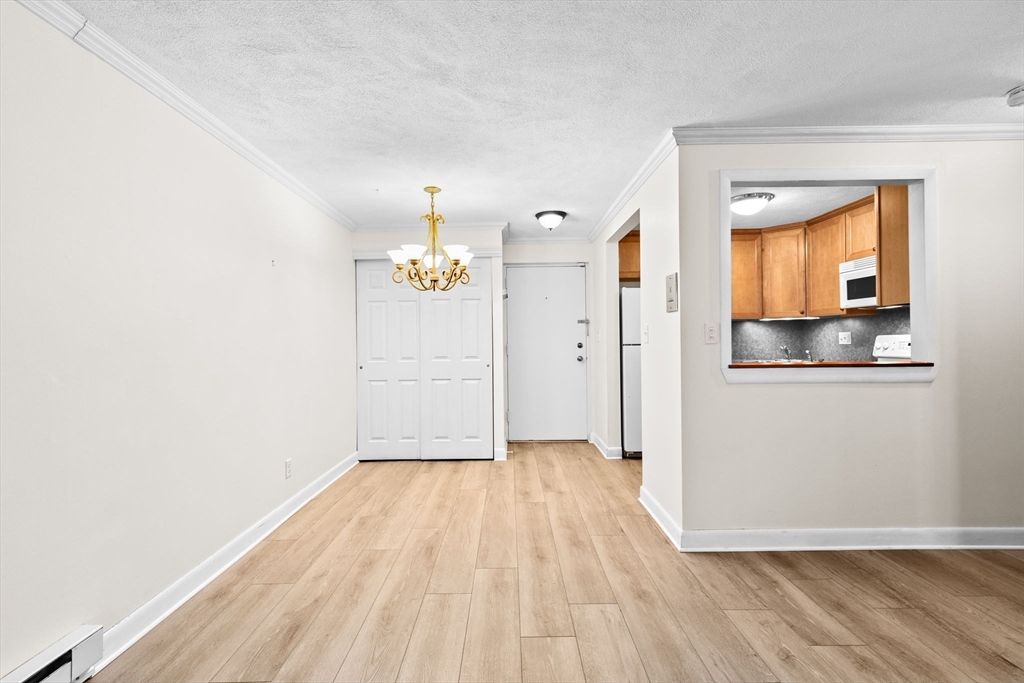 79 Fountain Lane, Unit 3 Weymouth, MA 02190 - Photo 7 of 29 a view of a room with wooden floor and an entryway