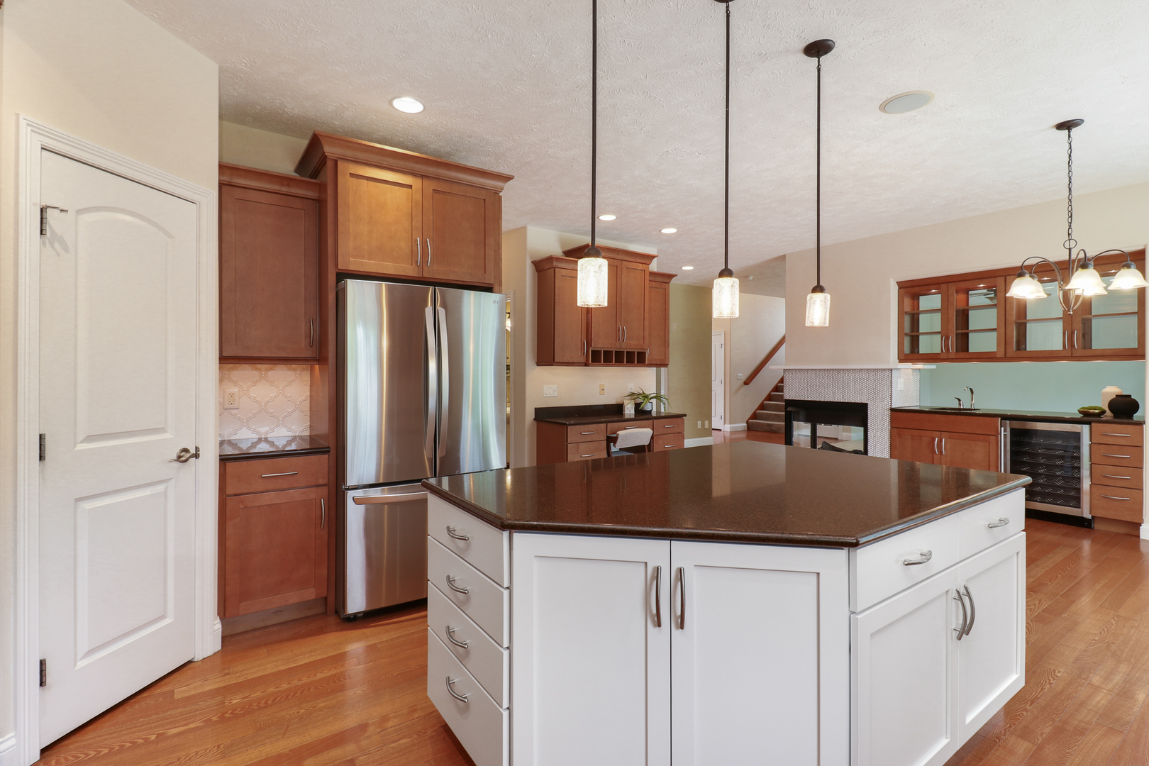 69 Brookstone Circle Bloomington, IL 61704 - Photo 23 of 63 a kitchen with stainless steel appliances granite countertop a refrigerator a sink and a wooden floor