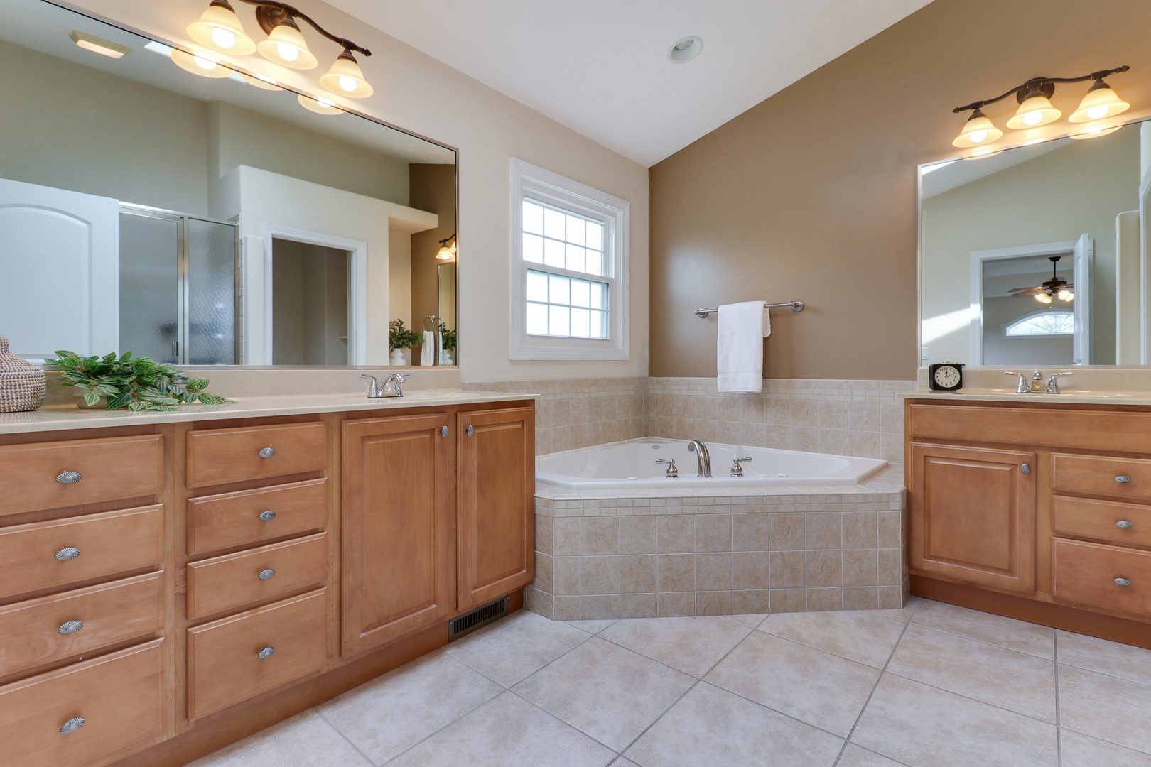 69 Brookstone Circle Bloomington, IL 61704 - Photo 33 of 63 a bathroom with a tub sink and mirror