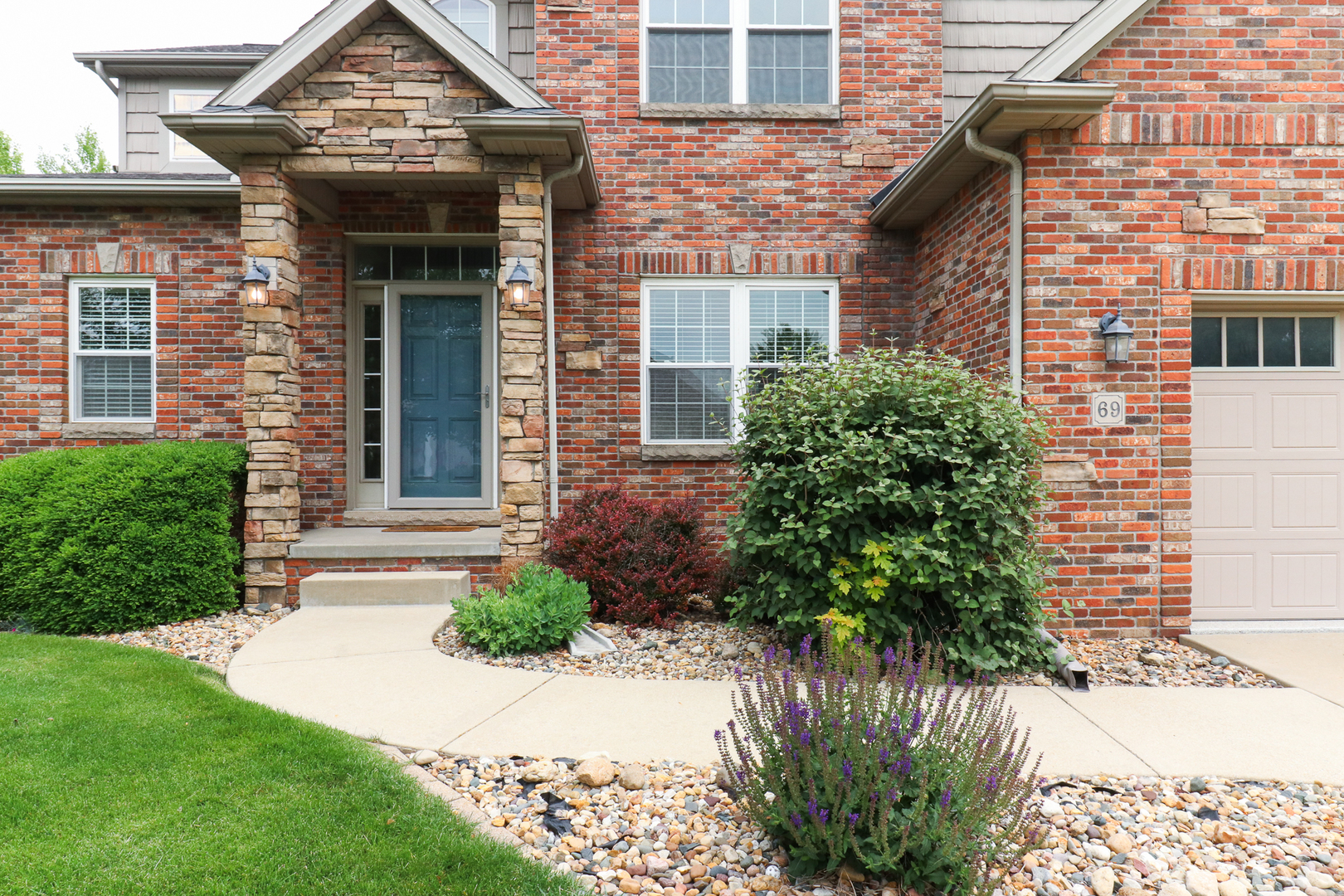 69 Brookstone Circle Bloomington, IL 61704 - Photo 4 of 63 a front view of a house with garden