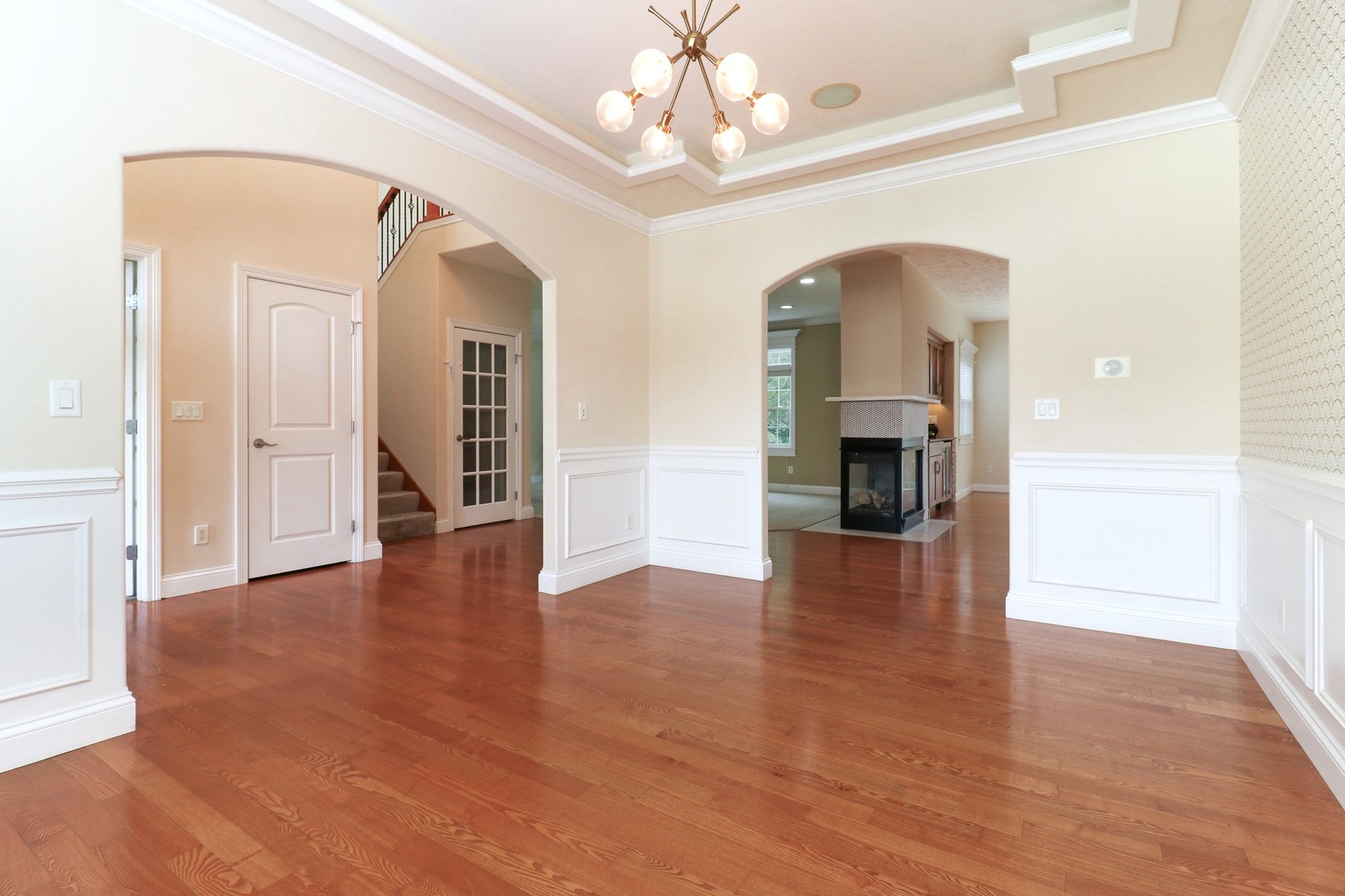 69 Brookstone Circle Bloomington, IL 61704 - Photo 6 of 63 a view of a hallway with wooden floor and a chandelier