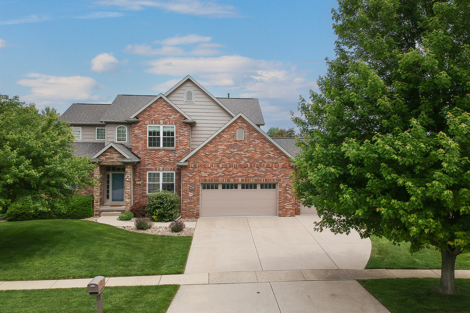 69 Brookstone Circle Bloomington, IL 61704 - Photo 63 of 63 a front view of a house with a garden and yard