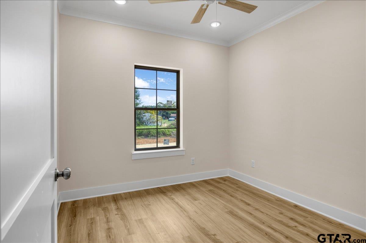 501 County Road 330 Tyler, TX 75708 - Photo 22 of 36 an empty room with wooden floor and windows