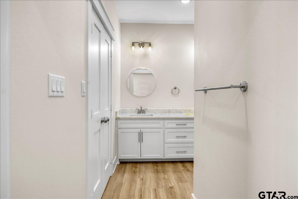 501 County Road 330 Tyler, TX 75708 - Photo 24 of 36 a bathroom with a granite countertop sink a mirror and shower view