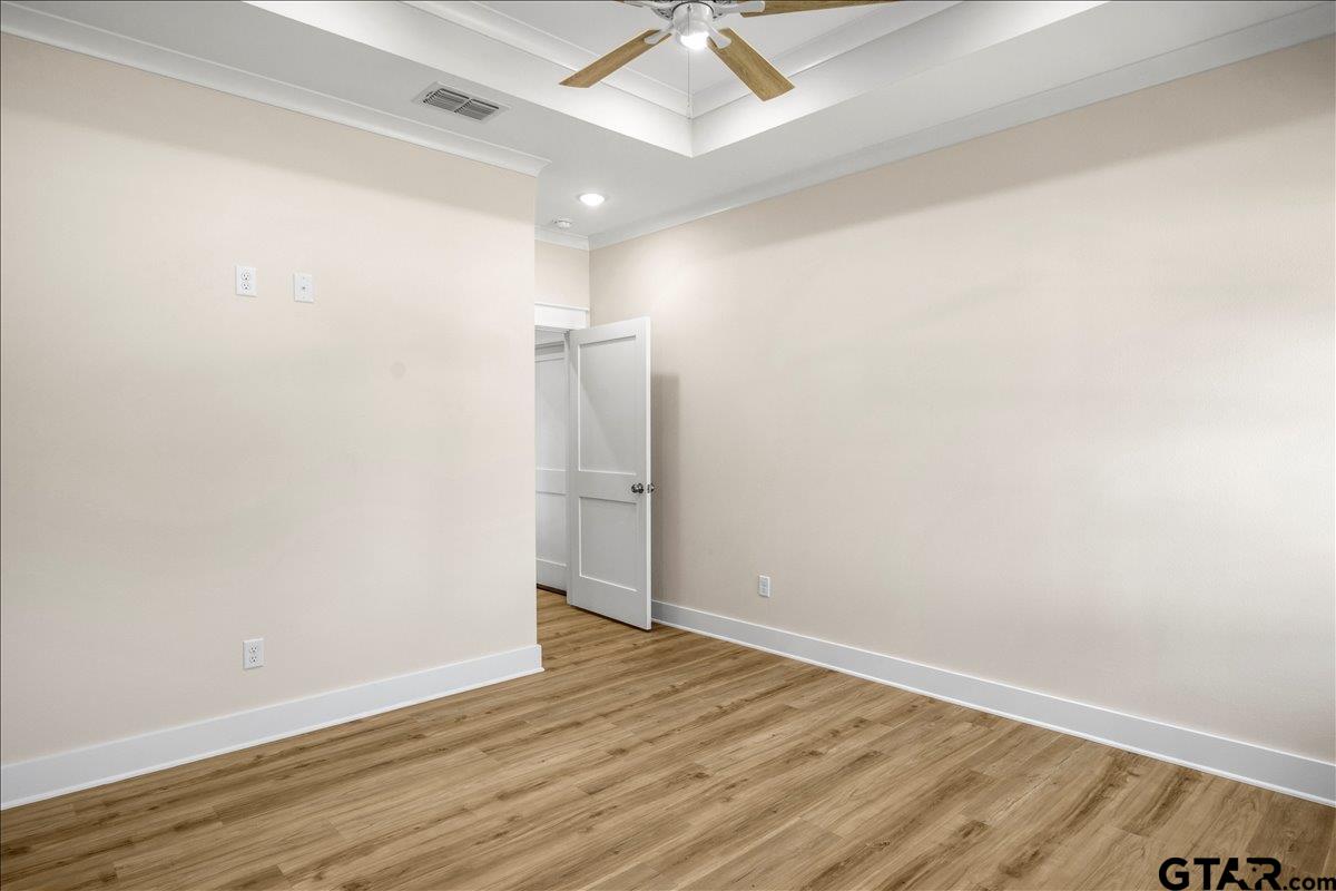 501 County Road 330 Tyler, TX 75708 - Photo 27 of 36 an empty room with wooden floor and fan