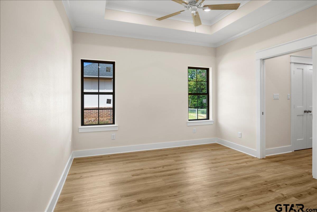 501 County Road 330 Tyler, TX 75708 - Photo 28 of 36 an empty room with wooden floor chandelier fan and windows