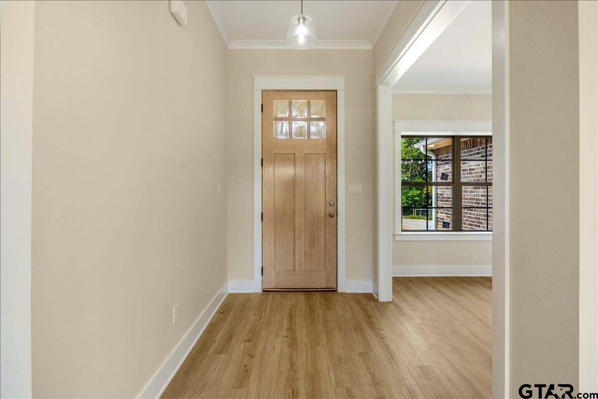501 County Road 330 Tyler, TX 75708 - Photo 7 of 36 an empty room with wooden floor and windows