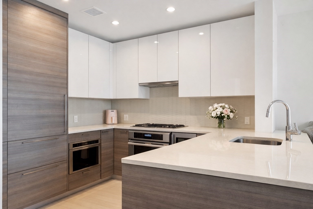 1 Franklin Street, Unit 1602 Boston, MA 02110 - Photo 5 of 14 a kitchen with a sink stove and cabinets