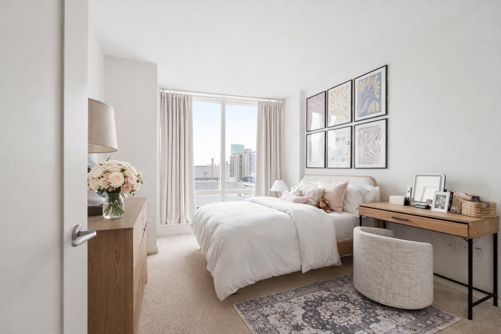 1 Franklin Street, Unit 1602 Boston, MA 02110 - Photo 6 of 14 a bedroom with bed and a window