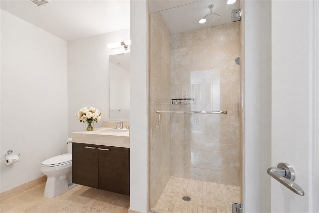 1 Franklin Street, Unit 1602 Boston, MA 02110 - Photo 8 of 14 a bathroom with a toilet a sink and shower