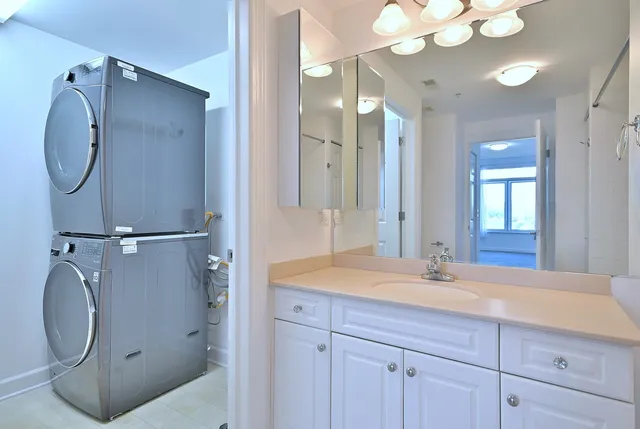 a bathroom with a granite countertop sink mirror and vanity