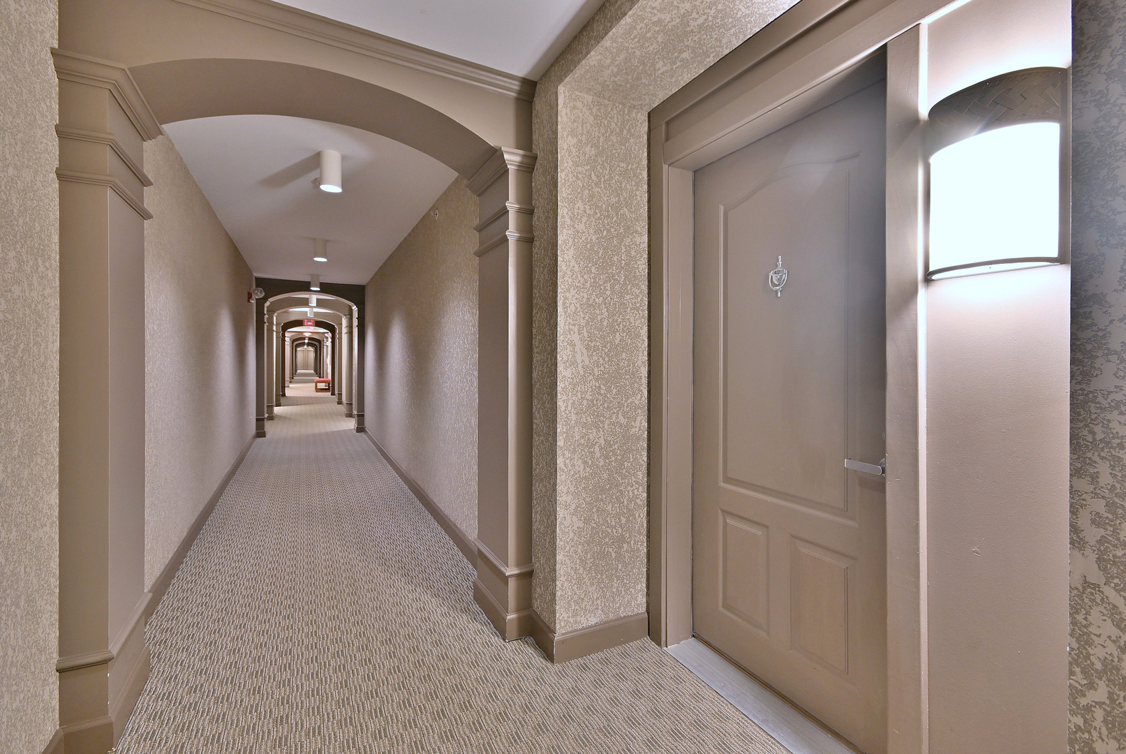 8300 Callie Avenue, Unit 412 Morton Grove, IL 60053 - Photo 28 of 28 a view of a hallway with wooden floor and staircase