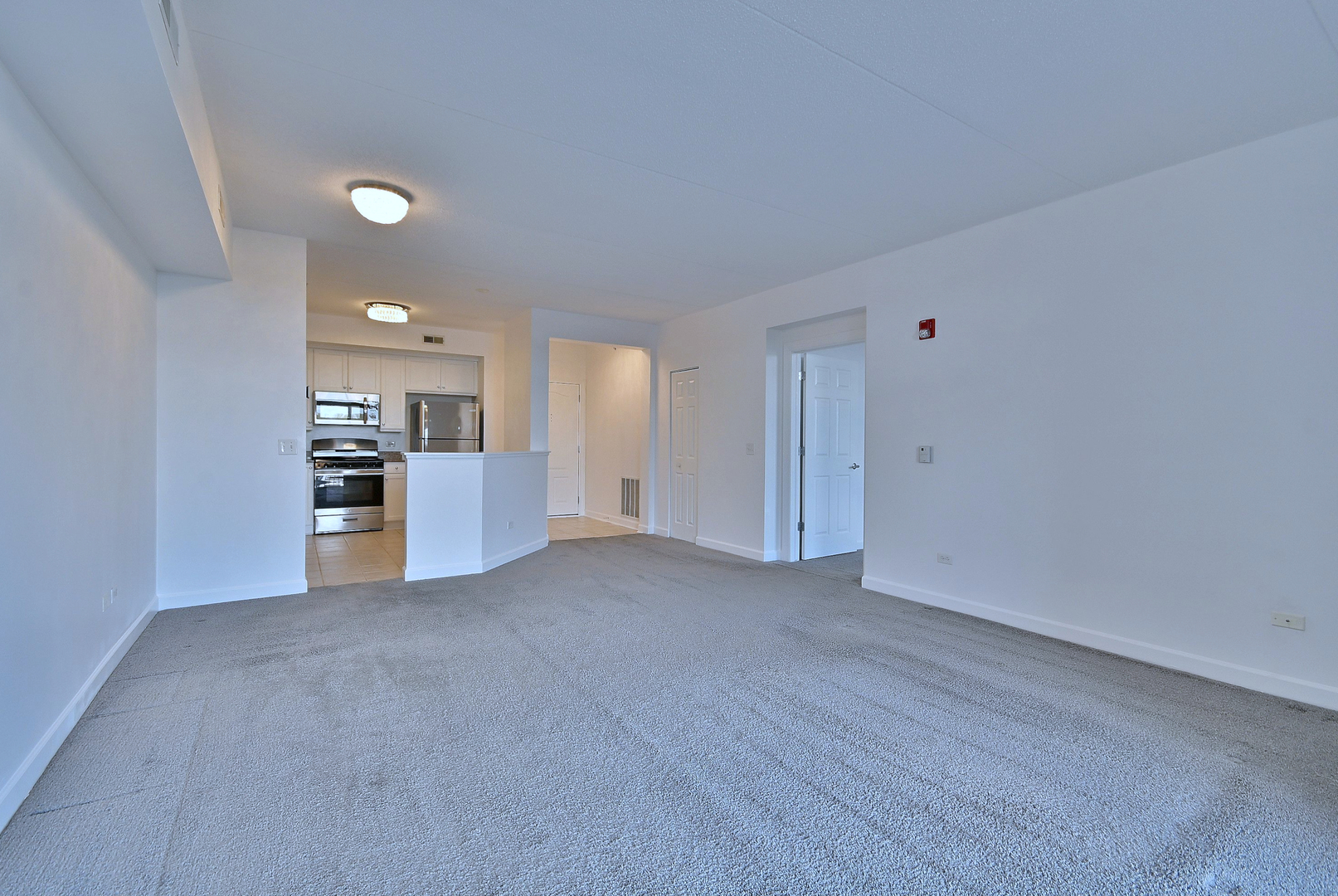 8300 Callie Avenue, Unit 412 Morton Grove, IL 60053 - Photo 5 of 28 a view of a kitchen with a sink and dishwasher cabinets