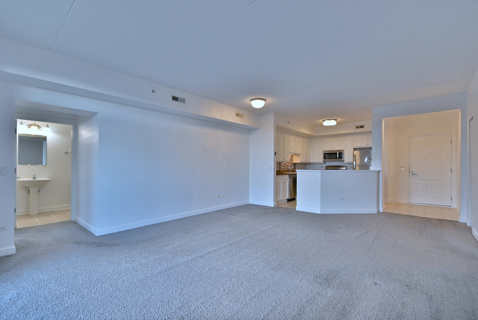 8300 Callie Avenue, Unit 412 Morton Grove, IL 60053 - Photo 10 of 28 a view of an empty room with a kitchen