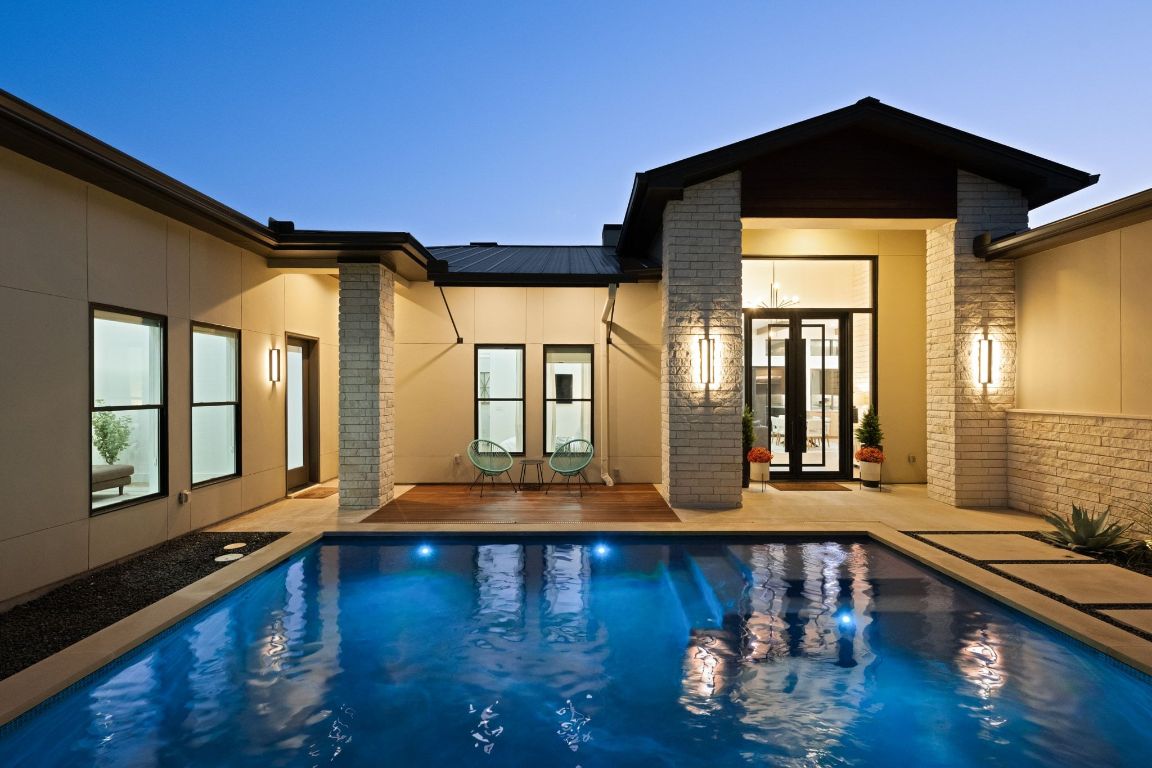 a view of a living room with hardwood floor and large windows